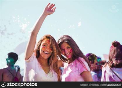 portrait smiling young women enjoying holi festival