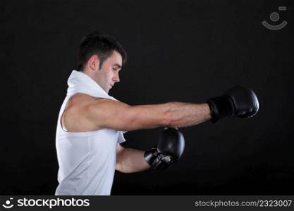 Portrait sportsman boxer in studio against dark background