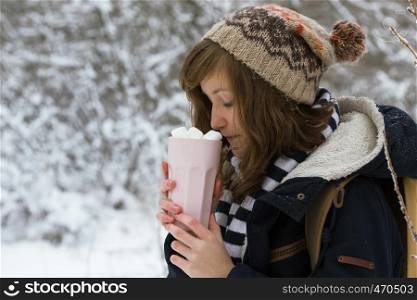 portrait teen girl holding a cup with marshmallows in the hands, christmas