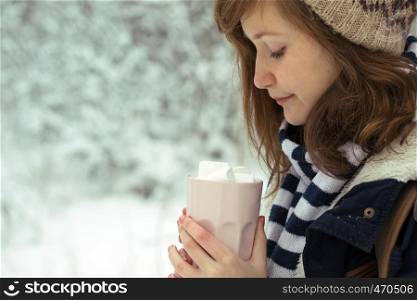 portrait teen girl holding a cup with marshmallows in the hands, christmas