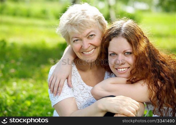 Portrait the daughter and elderly mother in park