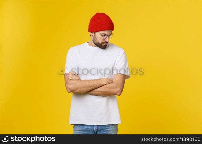 Portrait unhappy handsome man looking at camera on yellow background. Portrait unhappy handsome man looking at camera on yellow background.