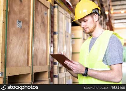 Portrait white caucasian warehouse worker use digital tablet working with inventory check in large warehouse distribution center. Reopening Business warehouse technology and logistic concept