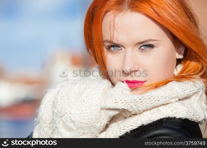 Portrait winter fashion beautiful woman red haired girl in warm clothing pink lips outdoor blue sky background