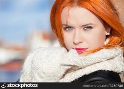 Portrait winter fashion beautiful woman red haired girl in warm clothing pink lips outdoor blue sky background