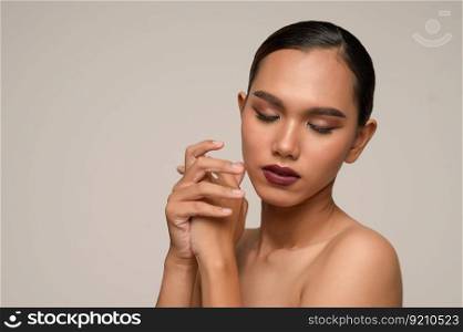 Portrait with manicure hands of beautiful asian woman hold her hands and close eyes, beautiful natural clean skin nature make up,  fresh spa female beauty cometic, copy space