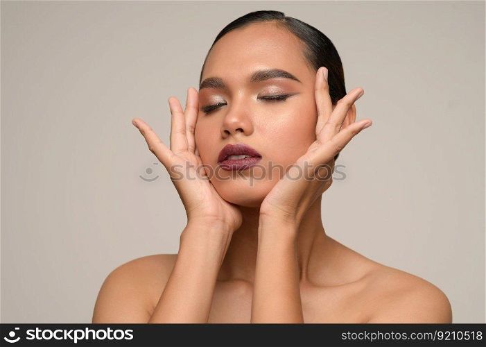 Portrait with manicure hands of beautiful asian woman touch cheek and close her eyes beautiful natural clean skin nature make up,  fresh spa female beauty cometic, copy space