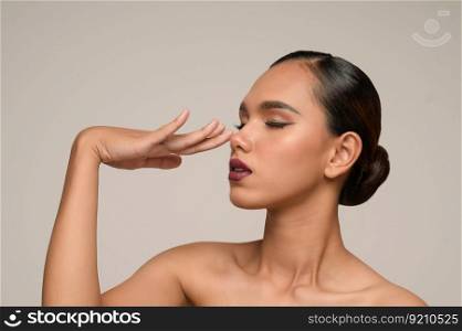 Portrait with manicure hands of beautiful asian woman touch nose and closed her eyes, beautiful natural clean skin nature make up,  fresh spa female beauty cometic, copy space