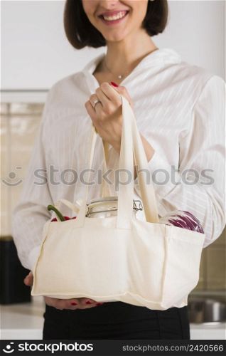 portrait woman holding organic groceries bag