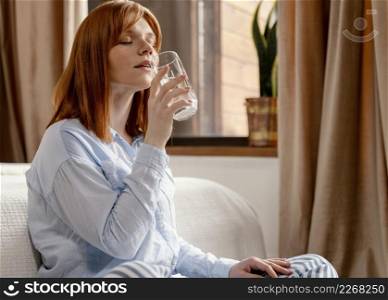portrait woman home drinking glass water