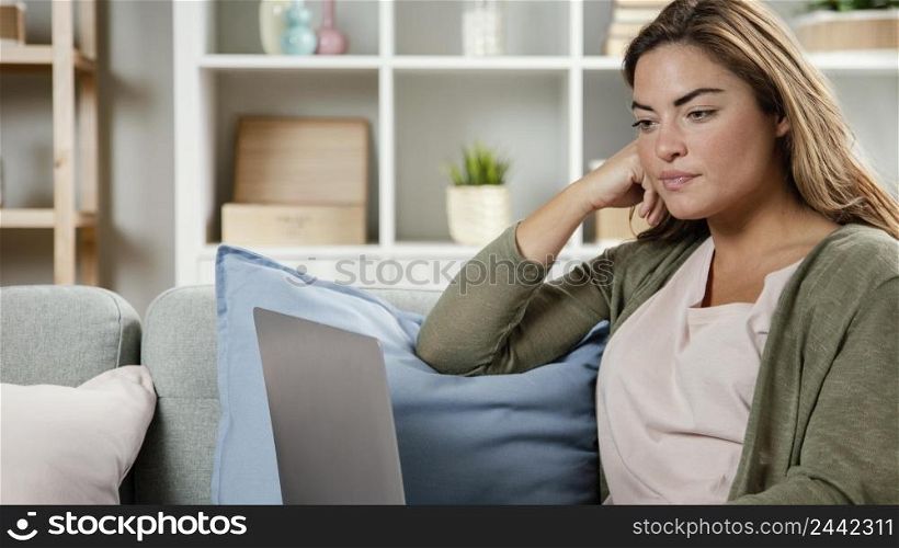 portrait woman home with laptop
