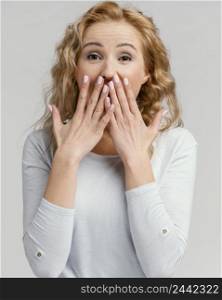 portrait woman laughing covering her mouth with hands