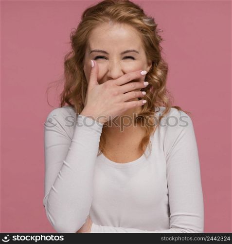 portrait woman laughing covers her mouth