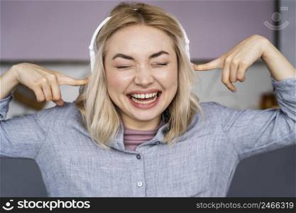 portrait woman laughing listening music headphones