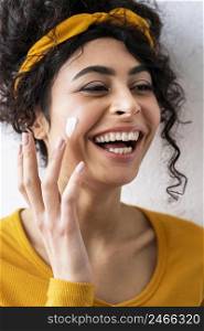 portrait woman laughing playing with moisturizer