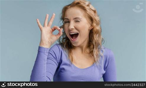 portrait woman laughing showing ok sign