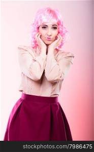 Portrait woman with pink wig creative visage makeup posing on gray background