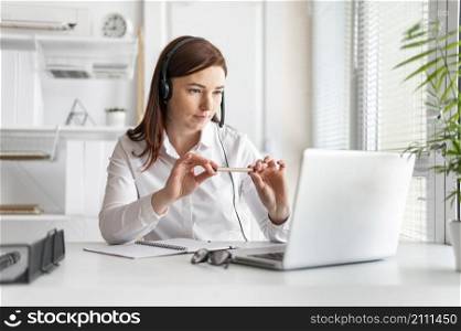 portrait woman work having video call laptop