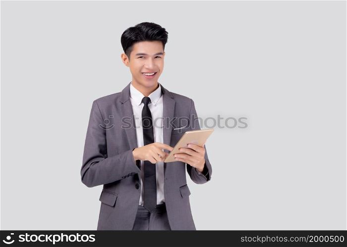 Portrait young asian business man in suit standing using tablet computer to internet isolated on white background, businessman confident touch screen digital pad with success, communication concept.