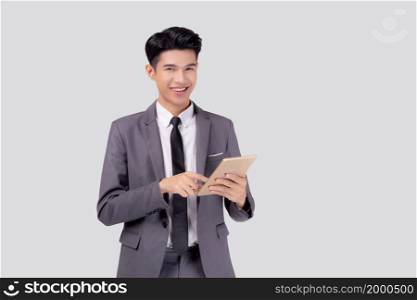 Portrait young asian business man in suit standing using tablet computer to internet isolated on white background, businessman confident touch screen digital pad with success, communication concept.