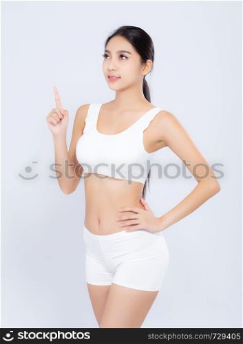 Portrait young asian woman smiling beautiful body diet with fit and finger pointing something isolated on white background, model girl weight slim with cellulite or calories, health and wellness concept.