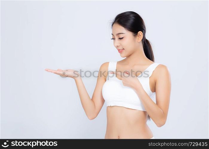 Portrait young asian woman smiling beautiful body diet with fit presenting something copy space on the hand isolated on white background, model girl weight slim with cellulite or calories, health and wellness concept.