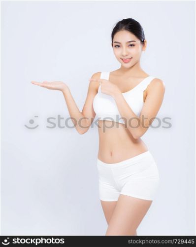Portrait young asian woman smiling beautiful body diet with fit presenting something copy space on the hand isolated on white background, model girl weight slim with cellulite or calories, health and wellness concept.