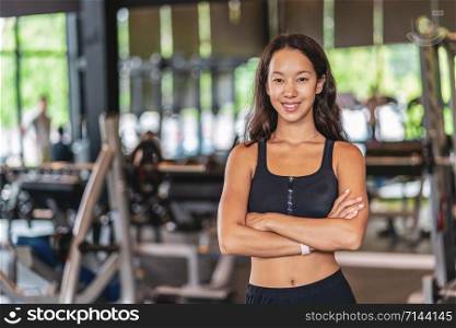 Portrait young asian woman wearing sportwear bra and pants fashion in fitness gym, sports and healthcare concept,