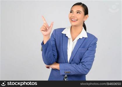 Portrait young beautiful woman in formal clothing for officer standing and point finger out with smile isolated on white background,  copy space for insert your advertisement