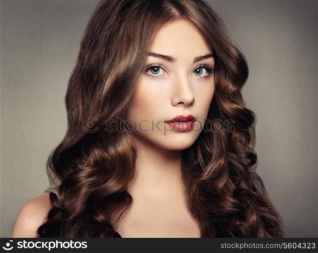 Portrait young beautiful woman with curly hair. Fashion photo
