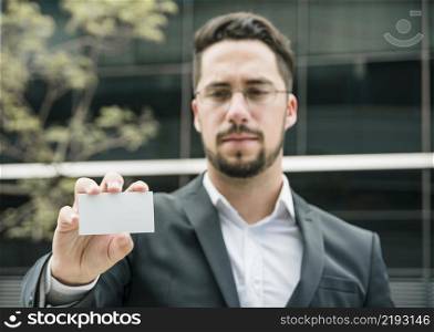 portrait young businessman showing blank white business card