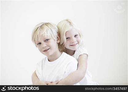 Portrait young girl hugging young boy