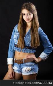 Portrait young girl in a blue jeans jacket, isolated on black background
