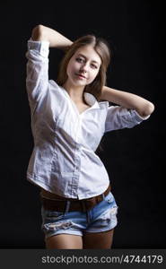 Portrait young girl in a blue jeans jacket, isolated on black background