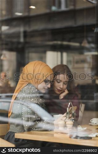 portrait young girls checking phone
