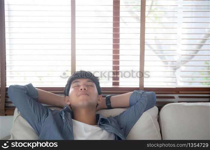 Portrait young handsome asian man napping relax with cozy on sofa at home, asia male resting and sleeping in weekend with tired and lazy on couch in vacation, lifestyle and wellbeing concept.