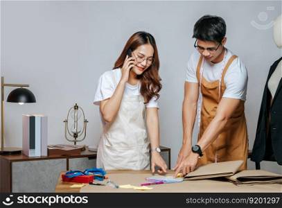 Portrait Young handsome man and pretty woman, Couple fashion designer working with colors wheel and paper clothing pattern at the studio at home