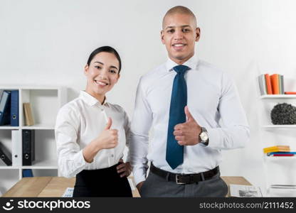 portrait young smiling businessman businesswoman showing thumb up sign