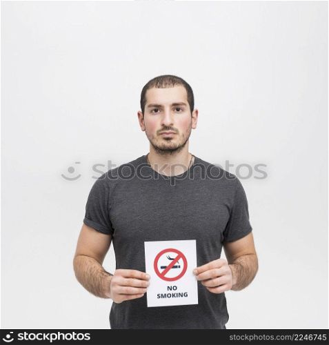 portrait young woman holding no smoking sign against white background