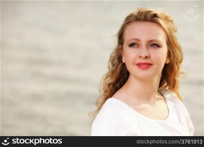 Portrait young woman smiling blonde girl on beach wind in hair , summer holiday
