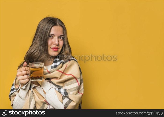 portrait young woman wrapped shawl holding herbal tea cup