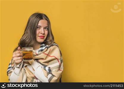 portrait young woman wrapped shawl holding herbal tea cup