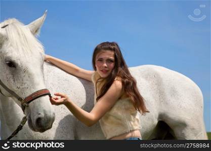 portraite of attractive girl with horse. outdoor shot
