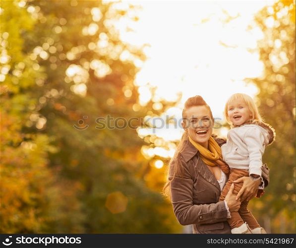 Portraits of happy young mother and baby outdoors