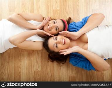 Portraits of two beautiful young women on the floor