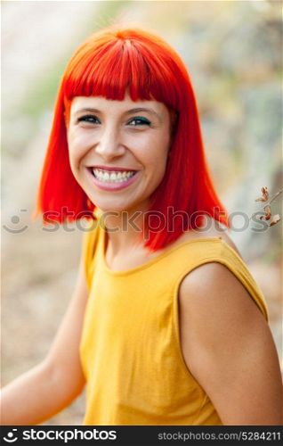 Portratif of red haired woman with yellow dress relaxed in a park
