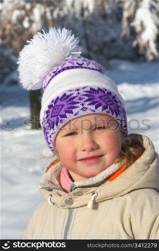 Portret of small girl in winter snow covered city park
