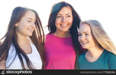 portret of three young beautiful woman on the sky background
