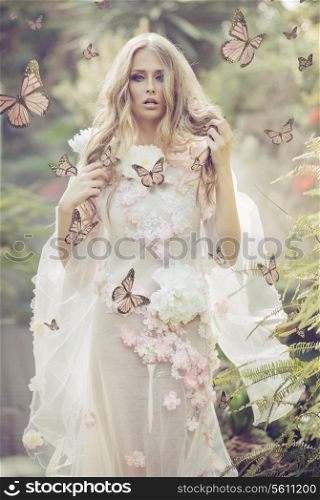 Portrhe young woman among the flying butterflies