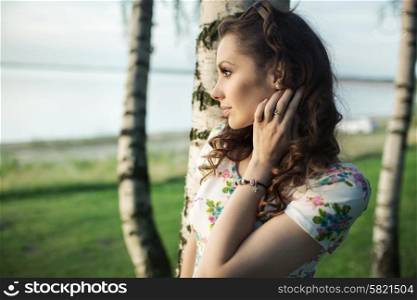 Portriat of the charming brunette looking at the sea